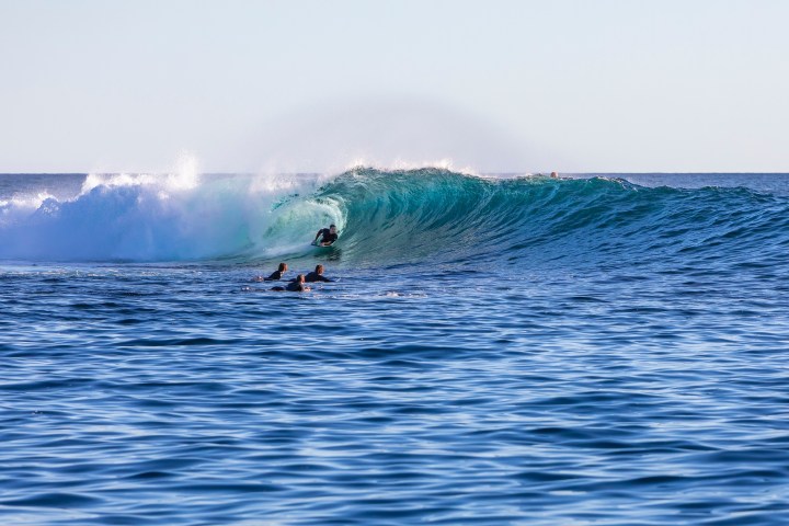 a man riding a wave on a surfboard in the ocean